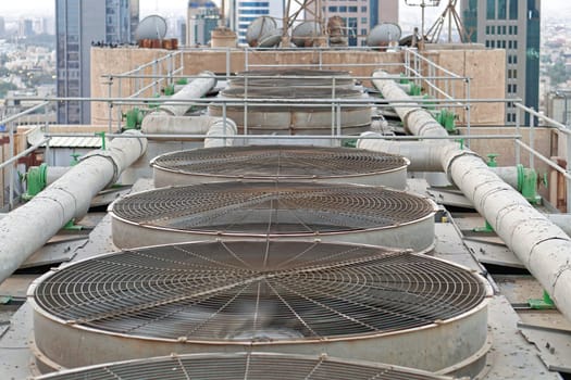 Big ventilation fans cooling system at top of building in Kuwait