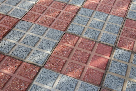 Grey and red brick sidewalks. Background mosaic texture.