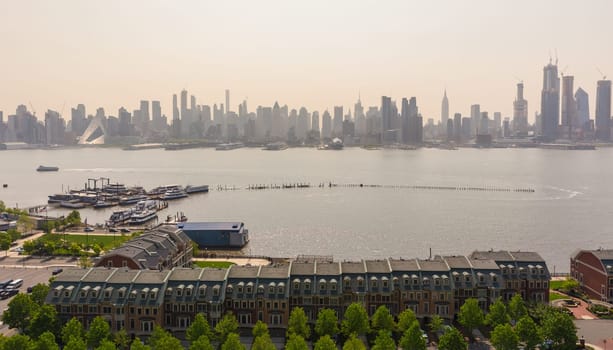 New York City midtown Manhattan sunset skyline panorama view from Boulevard East Old Glory Park over Hudson River.