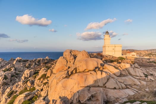 Lighthouse on granite rock formations at Capo Testa, Sardinia, Italy in sunset.