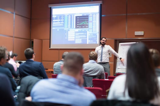 Public Speaker Giving a Talk at Business Meeting. Audience in the conference hall. Business and Entrepreneurship concept.