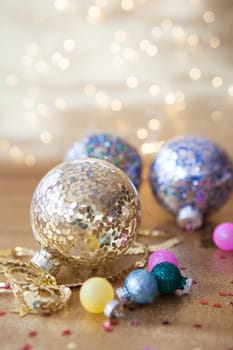Glittery christmas decorations in front of festive lights