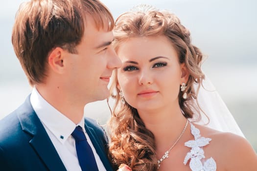 beautiful young couple posing in the park on a background of nature
