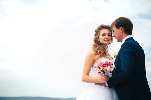 beautiful young couple posing in the park on a background of nature
