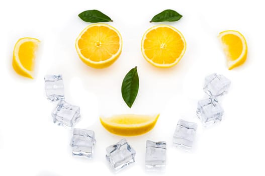 Bright lemon slices, green leaves and ice cubes in the shape of a face. healthy lifestyle.