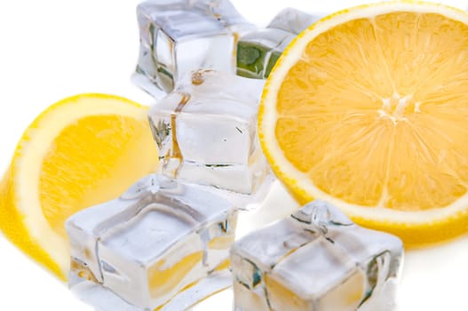 Half a juicy bright lemon and refreshing ice cubes close-up