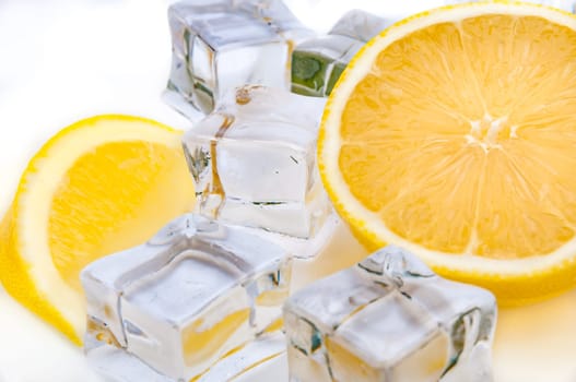 Half a juicy bright lemon and refreshing ice cubes close-up