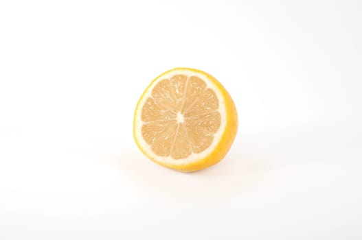 A slice of a juicy ripe lemon-shaped view at an angle isolated.