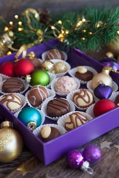 Box of chocolates with colorful baubles for a Merry Christmas