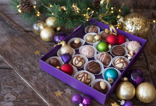 Box of chocolates with colorful baubles for a Merry Christmas