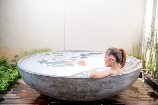 Beautiful asian woman relaxing on the bathtub