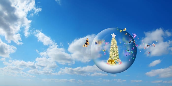 Decorated Christmas tree in glass sphere with group of butterflies floating in air over sunny sky