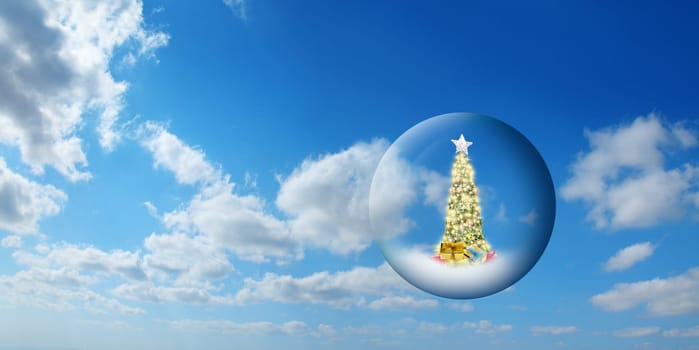 Conceptual image of decorated Christmas tree in glass sphere floating in air over sunny sky