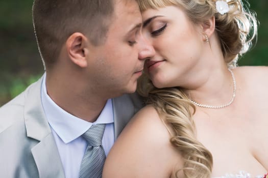 beautiful young couple stand on background forest