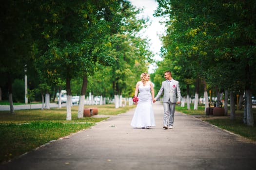 beautiful young couple stand on background forest