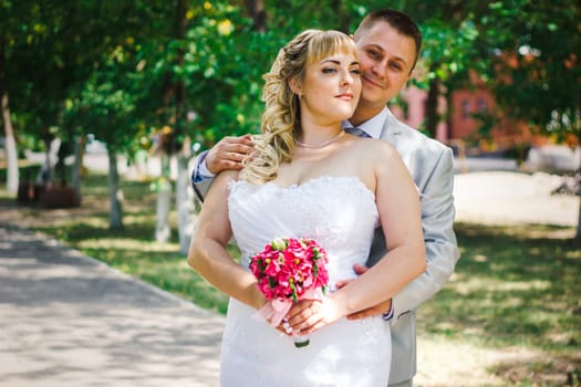 beautiful young couple stand on background forest