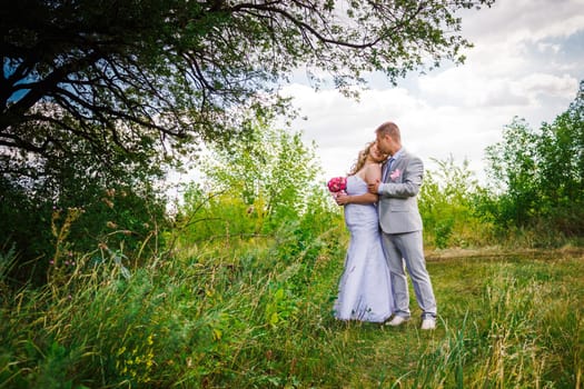 beautiful young couple stand on background forest