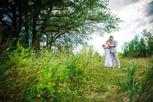 beautiful young couple stand on background forest