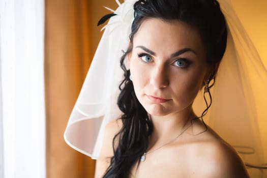 beautiful young bride stand on background forest