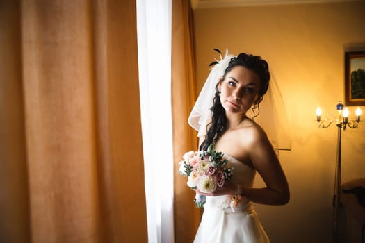 beautiful young bride stand on background forest