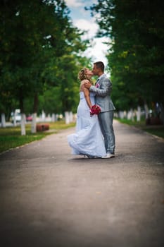 beautiful young couple stand on background forest