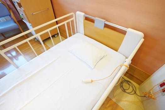 Room with empty bed and medical equipment in a hospital