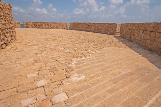 Old brick walkway on a Fotress Wall on the coastal fortress in Acre, Israel