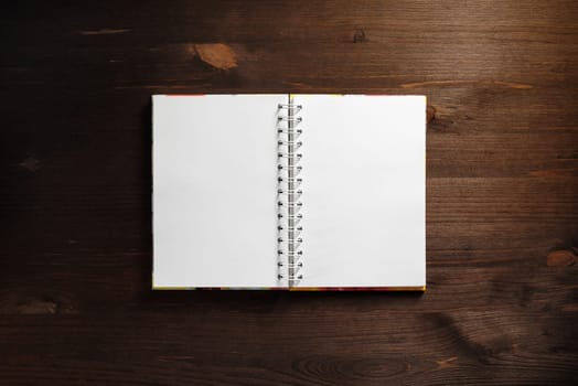 Blank notepad on wood table background. Template for branding identity. Flat lay.