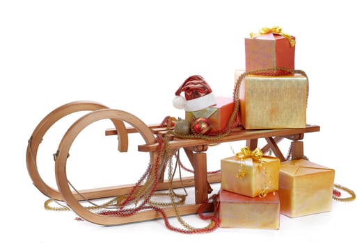 Wooden sledge with gift boxes and Christmas decoration isolated on a white background. Christmas and New Year.