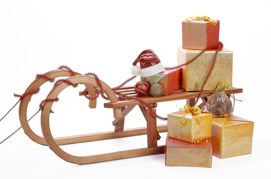 Wooden sledge with gift boxes and Christmas decoration isolated on a white background. Christmas and New Year.