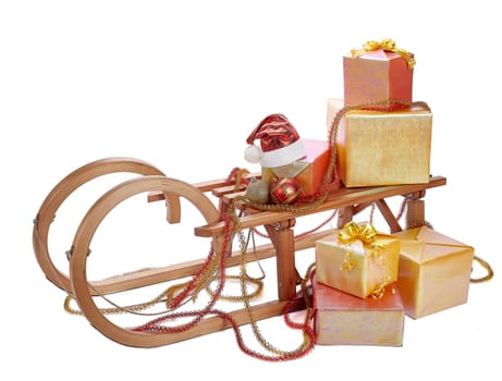Wooden sledge with gift boxes and Christmas decoration isolated on a white background. Christmas and New Year.