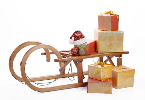 Wooden sledge with gift boxes and Christmas decoration isolated on a white background. Christmas and New Year.