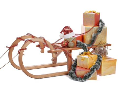 Wooden sledge with gift boxes and Christmas decoration isolated on a white background. Christmas and New Year.