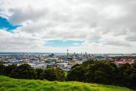 Auckland view from Mt Eden with a person walking along the path towards the city, New Zealand