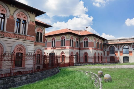 Entrance to the factory of Crespi d'Adda. The entrance is characterized by the so-called "red gates"" in wrought iron."