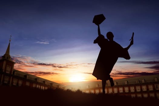 Silhouette of happy student woman celebrating graduation on campus