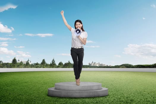 Beautiful asian businesswoman giving speech with megaphone on podium