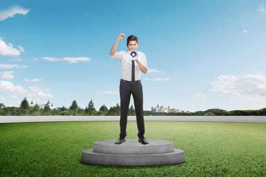 Handsome asian businessman standing and using megaphone on podium