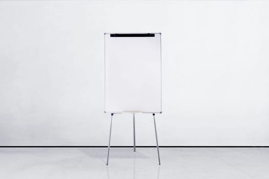 Standing white board inside room with white wall background