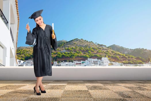 Pretty asian woman with graduation cap and diploma scroll on graduation ceremony