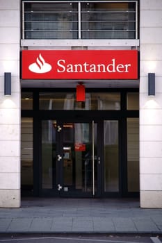 Wiesbaden, Germany - September 25, 2018: The entrance of Santander Bank with a bright red name badge and a glass door on September 25, 2018 in Wiesbaden....