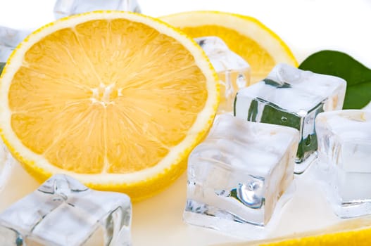 Half a juicy lemon and refreshing ice cubes close-up