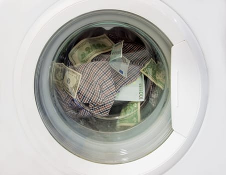 Money laundering in a washing machine along with linens.