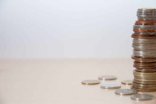 A stack of coins of different countries, color, dignity and size on the right at the edge.