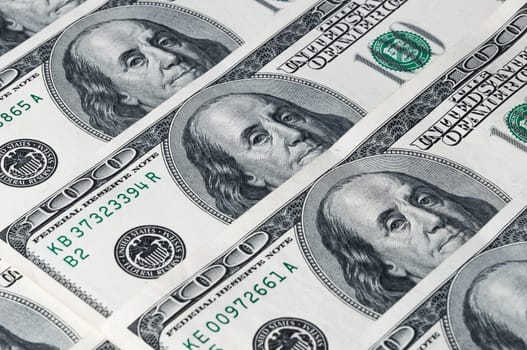A background of hundred dollar bills arranged diagonally.