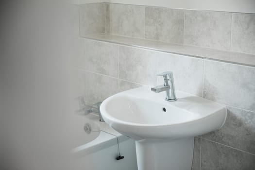 Close up shot of a bathroom sink in a new home.
