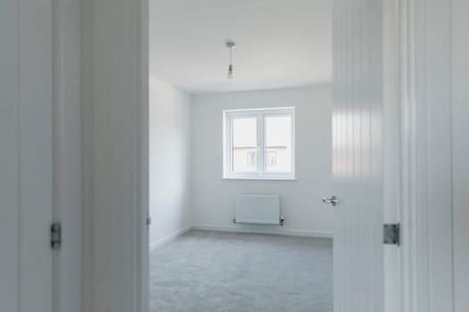 Room shot of an unfurnished bedroom in a new home.