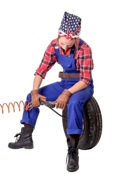 Vintage  young woman inflates a car tire on the white background