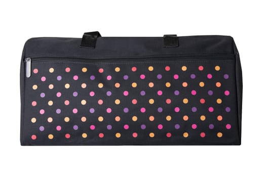 Bags fashion. Closeup of multicolored dotted overnight bag on a white background. Travel concept.