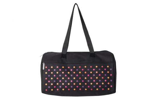 Bags fashion. Closeup of multicolored dotted overnight bag on a white background. Travel concept.